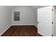 Spacious bedroom with dark hardwood floors and neutral walls at 7502 Springbox Dr, Fairburn, GA 30213