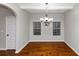 Dining room with hardwood floors and chandelier at 7502 Springbox Dr, Fairburn, GA 30213