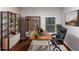 Home office with hardwood floors and built-in shelving at 7502 Springbox Dr, Fairburn, GA 30213