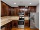 Kitchen features dark wood cabinets and granite countertops at 7502 Springbox Dr, Fairburn, GA 30213