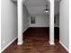 Open living area with hardwood floors and arched entryways at 7502 Springbox Dr, Fairburn, GA 30213