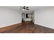 Open living room with hardwood floors and view of kitchen at 7502 Springbox Dr, Fairburn, GA 30213