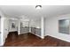 Open loft area with dark hardwood floors and neutral walls at 7502 Springbox Dr, Fairburn, GA 30213