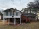 Elevated deck with sunroom and stairs leading to the yard at 2289 Aurie Dr, Decatur, GA 30034