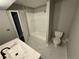 Bathroom with new bathtub, toilet, and marble-look tile at 2289 Aurie Dr, Decatur, GA 30034