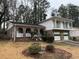 Two-story brick home with a double-car garage and mature trees at 2289 Aurie Dr, Decatur, GA 30034