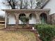 Brick front porch with arched entryway and green door at 2289 Aurie Dr, Decatur, GA 30034