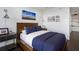 Cozy bedroom with a wooden bed frame and city skyline art at 3630 Peachtree Ne Rd # 2104, Atlanta, GA 30326