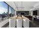 Modern dining area with city views, wood table, and white chairs at 3630 Peachtree Ne Rd # 2104, Atlanta, GA 30326