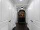 Hallway with dark wood floors and white doors leading to a built-in cabinet at 3630 Peachtree Ne Rd # 2104, Atlanta, GA 30326