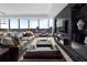 Modern living room with panoramic city views, leather furniture and custom entertainment center at 3630 Peachtree Ne Rd # 2104, Atlanta, GA 30326