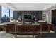 Living room with leather sectional and city views at 3630 Peachtree Ne Rd # 2104, Atlanta, GA 30326
