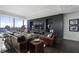 Modern living room features dark wood floors, a large window showcasing city views, and comfortable leather furniture at 3630 Peachtree Ne Rd # 2104, Atlanta, GA 30326