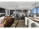 Open concept living area with leather sofas and modern finishes at 3630 Peachtree Ne Rd # 2104, Atlanta, GA 30326