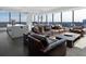 Spacious living room with floor to ceiling windows, leather sofas, and city views at 3630 Peachtree Ne Rd # 2104, Atlanta, GA 30326