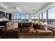 Spacious living room boasts a large leather sofa and city views at 3630 Peachtree Ne Rd # 2104, Atlanta, GA 30326