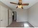 Bright bedroom featuring ceiling fan and ample closet space at 5370 Biffle Ln, Stone Mountain, GA 30088