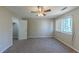 Spacious bedroom with ceiling fan and window at 5370 Biffle Ln, Stone Mountain, GA 30088