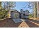 Rear view of a house showing a patio and surrounding trees at 5370 Biffle Ln, Stone Mountain, GA 30088