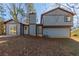 Two-story house with blue siding, a deck, and a spacious backyard at 5370 Biffle Ln, Stone Mountain, GA 30088