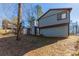 Side view of a two-story house with wood siding and a spacious backyard at 5370 Biffle Ln, Stone Mountain, GA 30088