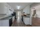 Clean kitchen featuring white cabinets, granite countertops, and a door to outside at 5370 Biffle Ln, Stone Mountain, GA 30088