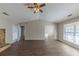 Open living room with hardwood floors, a fireplace, and access to other rooms at 5370 Biffle Ln, Stone Mountain, GA 30088