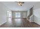 Bright living room with hardwood floors, a ceiling fan, and stairs at 5370 Biffle Ln, Stone Mountain, GA 30088