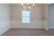 Formal dining room with wainscoting and elegant chandelier at 950 Spanish Moss Trl, Loganville, GA 30052