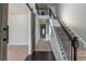 Two-story entryway with a wooden barn door and wrought iron staircase at 950 Spanish Moss Trl, Loganville, GA 30052