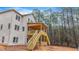 Backyard view of a two-story home featuring a wooden deck and stairs at 4271 Matisse Ln, Fairburn, GA 30213