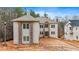 Newly built two story home with light brick facade and stone accents under a cloudy sky at 4271 Matisse Ln, Fairburn, GA 30213