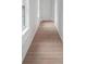 Hallway featuring light hardwood floors, white trim, and a window providing natural light at 4271 Matisse Ln, Fairburn, GA 30213