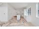 Unfinished kitchen with white cabinets, a center island, and large windows for natural light at 4271 Matisse Ln, Fairburn, GA 30213