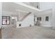 Open concept living space with tall ceilings, stairs to second floor and large glass French doors at 4271 Matisse Ln, Fairburn, GA 30213