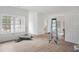 Bright, unfinished living room with large windows offering backyard views and white trim work at 4271 Matisse Ln, Fairburn, GA 30213