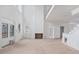 Bright living room with tall ceilings, a fireplace, large windows, and unfinished hardwood floors at 4271 Matisse Ln, Fairburn, GA 30213