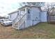 Side view of the home with stairs leading to the back entrance and a trampoline visible at 840 Forrest St, Roswell, GA 30075