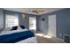 Well-lit bedroom featuring a comfortable bed and blue accents at 125 Lamberth Lake Dr, Fayetteville, GA 30215