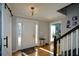 Bright entryway with hardwood floors, barn door, and staircase at 125 Lamberth Lake Dr, Fayetteville, GA 30215