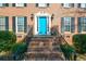 Brick home with blue front door, brick steps, and black railings at 125 Lamberth Lake Dr, Fayetteville, GA 30215