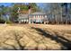 Two-story brick home with a large front yard and trees at 125 Lamberth Lake Dr, Fayetteville, GA 30215