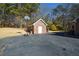 Detached brick garage with a basketball hoop nearby at 125 Lamberth Lake Dr, Fayetteville, GA 30215