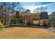 Brick house back view, deck, screened porch, and yard at 125 Lamberth Lake Dr, Fayetteville, GA 30215