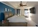 Main bedroom with a blue accent wall, large bed, and ample natural light at 125 Lamberth Lake Dr, Fayetteville, GA 30215