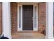 Dark brown front door with sidelights, brick exterior at 3348 Chastain Gardens Nw Dr, Kennesaw, GA 30144