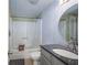 Clean bathroom with tub shower, granite vanity, and decorative wall paper at 1280 W Peachtree Nw St # 2207, Atlanta, GA 30309