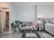 Cozy sitting area in bedroom with gray sofa and plant at 1280 W Peachtree Nw St # 2207, Atlanta, GA 30309