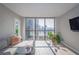 Bright living room with city views, comfy sectional sofa, and hardwood floors at 1280 W Peachtree Nw St # 2207, Atlanta, GA 30309
