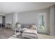 Spacious living room featuring a sectional sofa and access to a balcony at 1280 W Peachtree Nw St # 2207, Atlanta, GA 30309